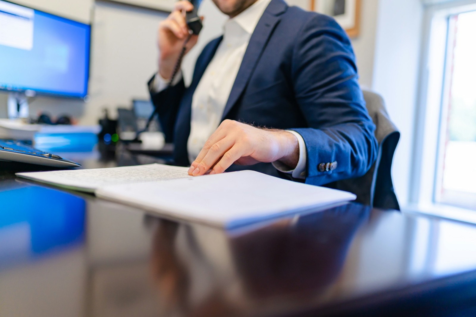 Attorney reviewing documents at a desk, representing a law firm auditing what its Google Ads program actually produces in signed cases.