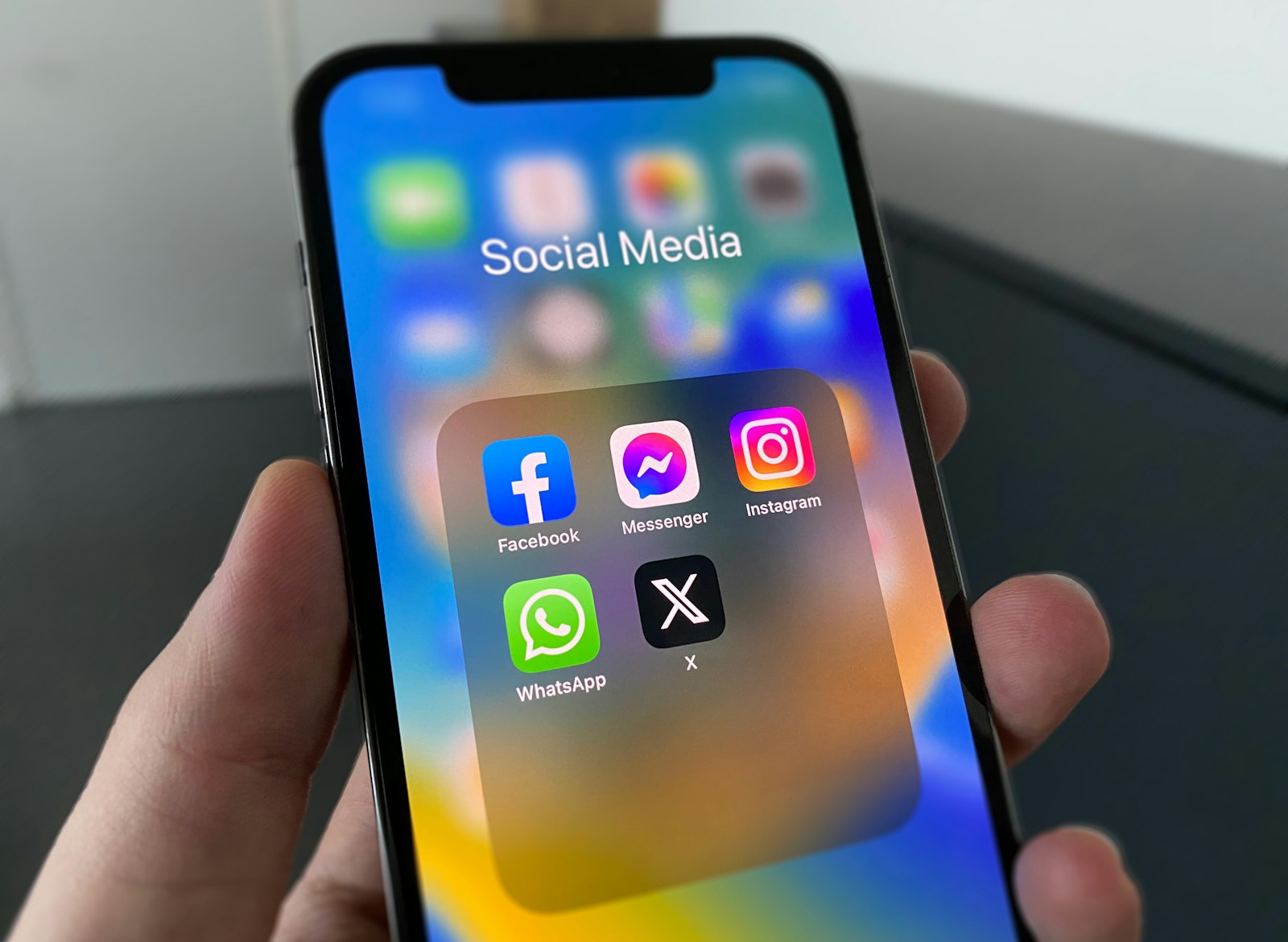 A person holding a phone with a social media feed on screen, illustrating how Meta ads reach law firm prospects mid-scroll.