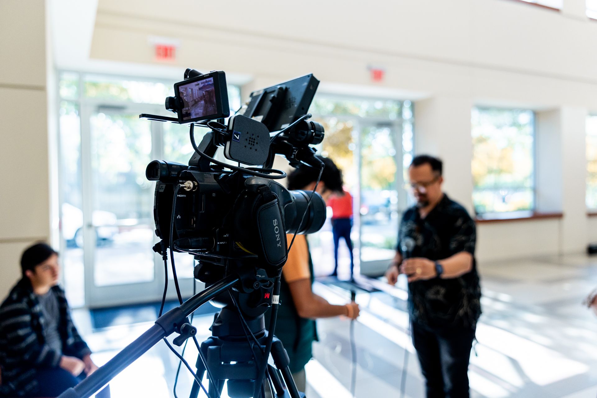Professional video camera set up on a tripod during a video shoot, illustrating YouTube ad production for law firms.