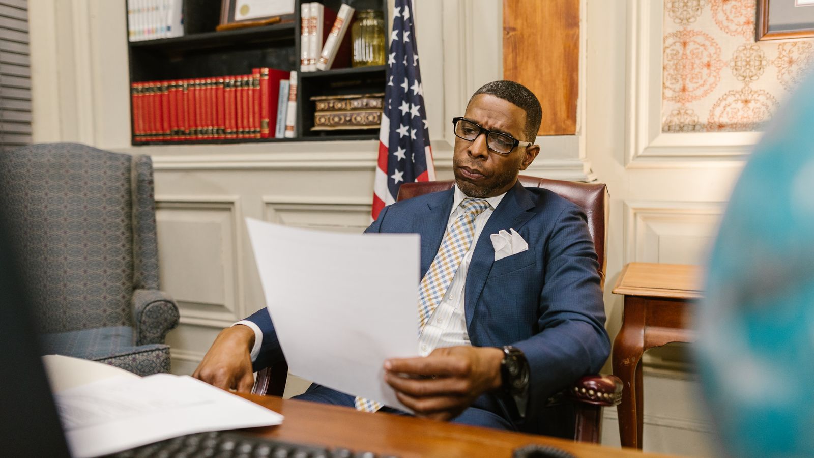 Personal injury attorney at his desk reviewing a case file in a law office.