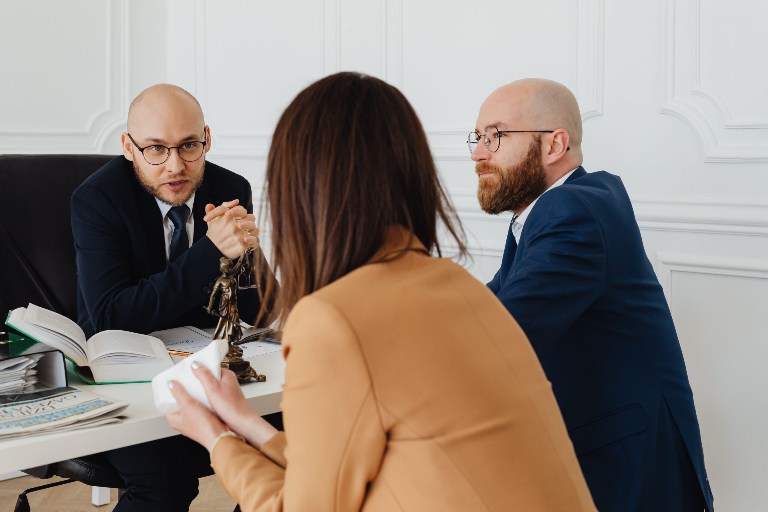 Two attorneys at a personal injury firm reviewing marketing performance in their office.
